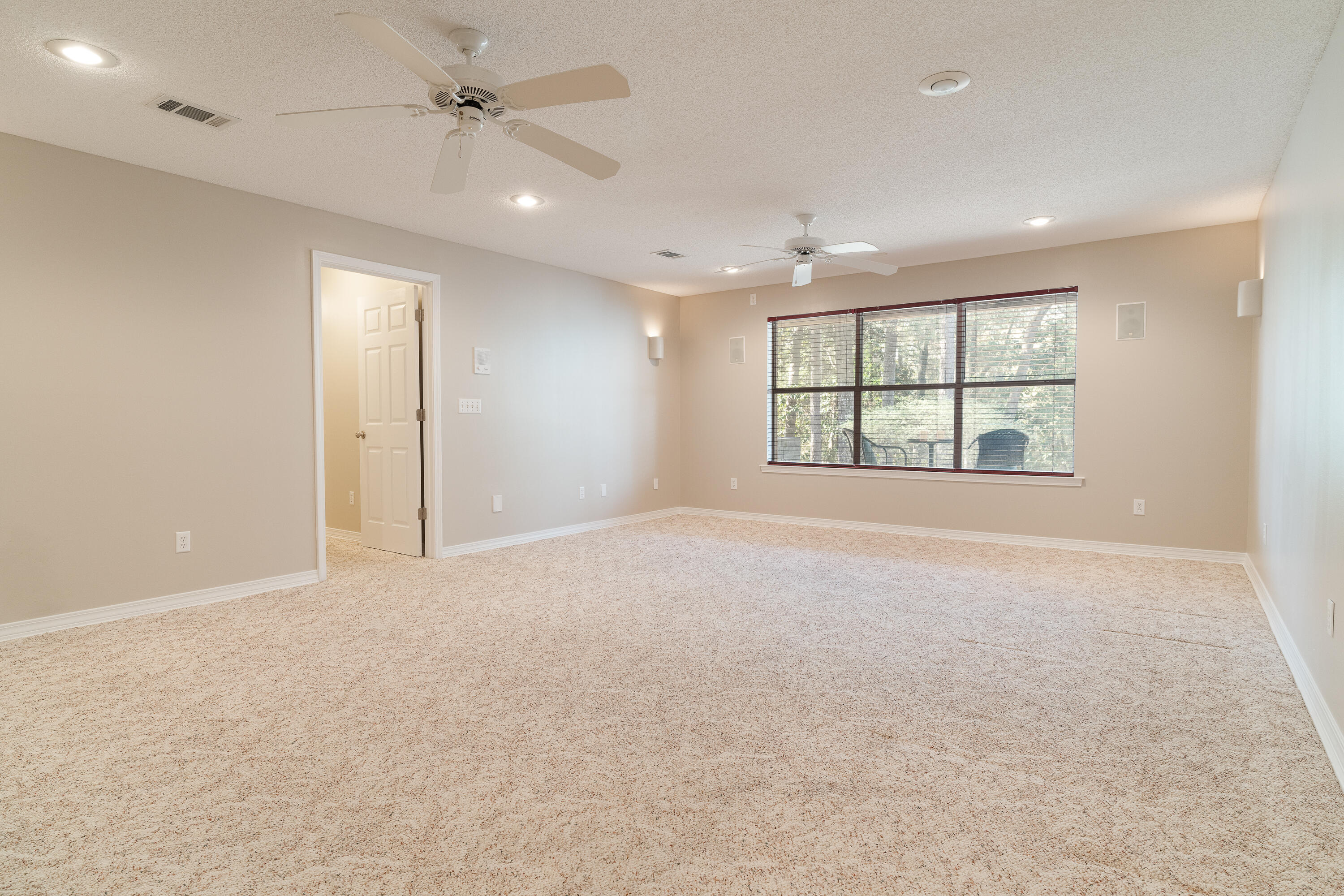 4100 Howard Drive Niceville, FL 32578 - Photo 80 of 133 an empty room with windows and ceiling fan