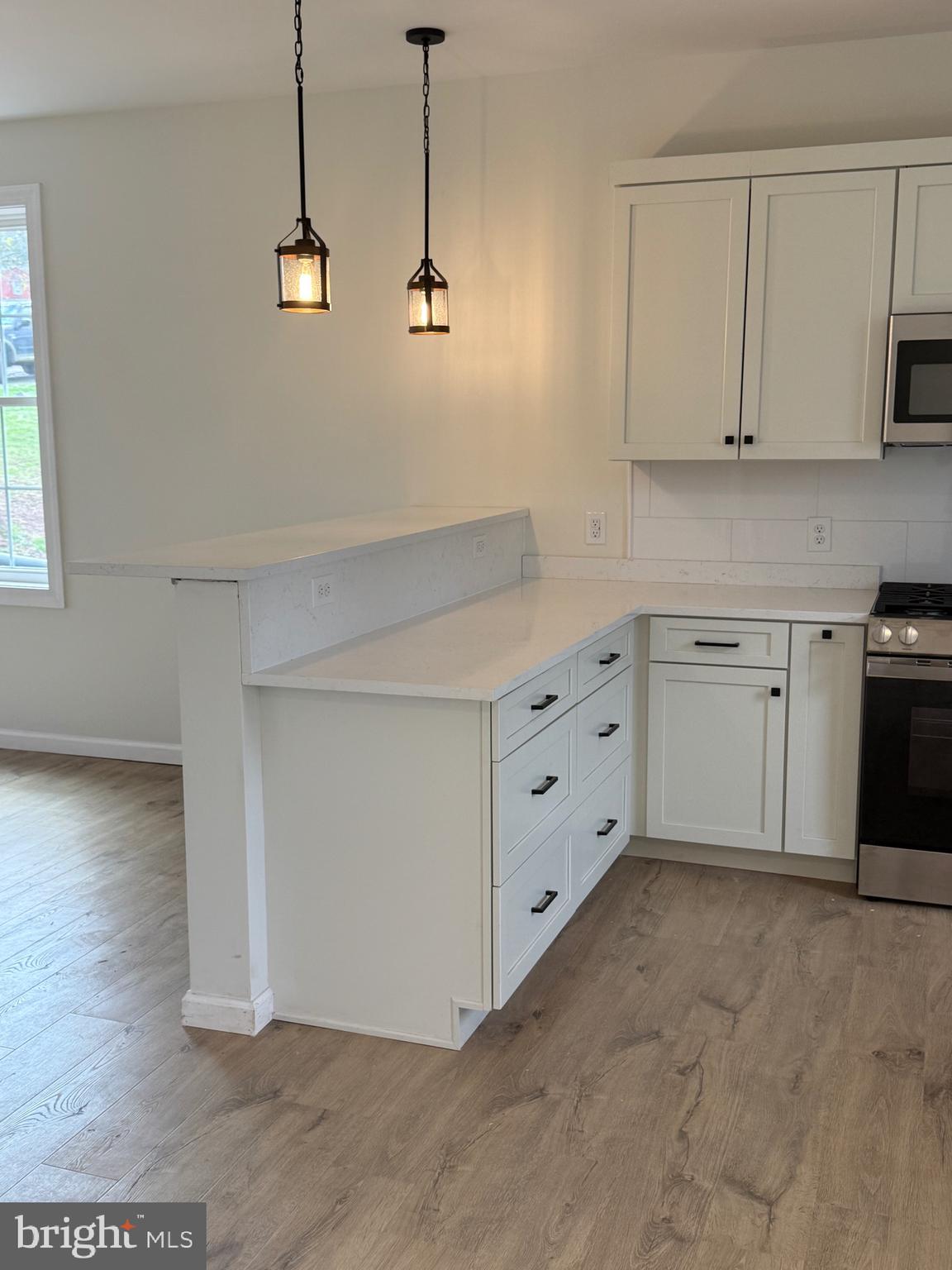 7 Orchard Alley Spring Spring City, PA 19475 - Photo 11 of 47 a kitchen with white cabinets and wooden floor