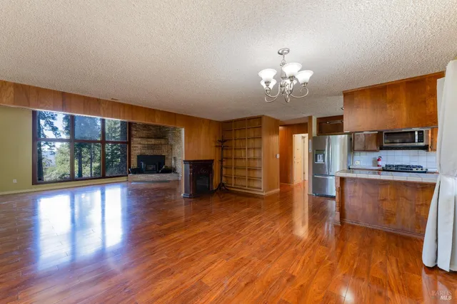 a view of kitchen with granite countertop cabinets and wooden floor