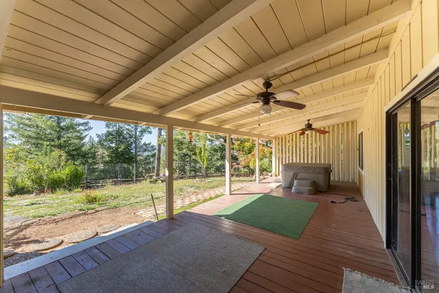 a view of a porch with wooden floor and roof