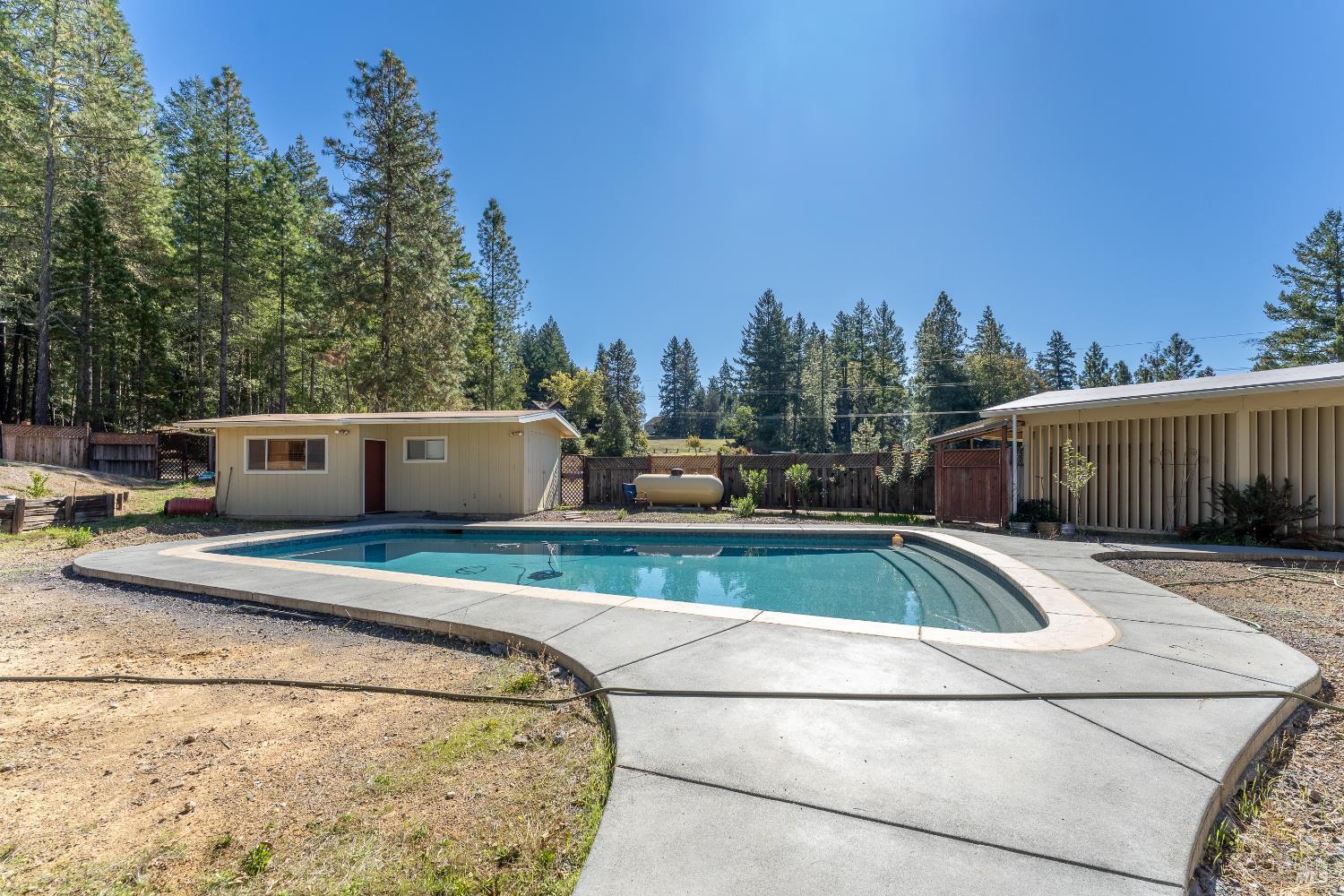 3651 Ridgewood Road Willits, CA 95490 - Photo 27 of 45 a view of a white house with a swimming pool and sitting area