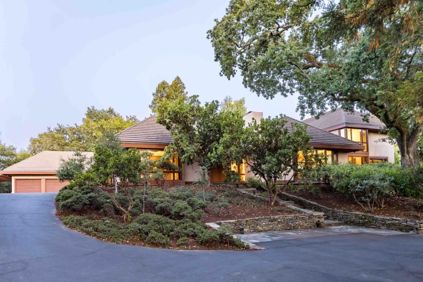 a view of a house with a yard and potted plants