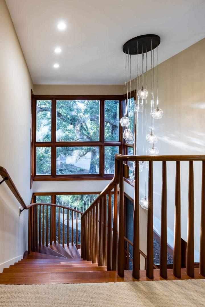 140 Farm Road Woodside, CA 94062 - Photo 18 of 39 a view of staircase with railing and lots of windows