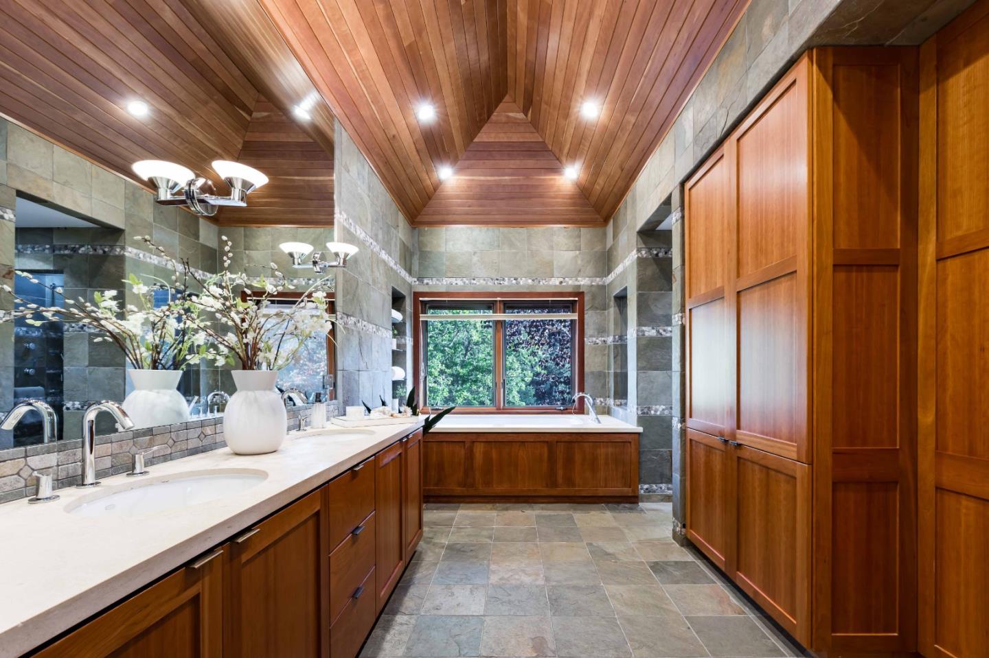 140 Farm Road Woodside, CA 94062 - Photo 21 of 39 a bathroom with a double vanity sink a large mirror and a bathtub