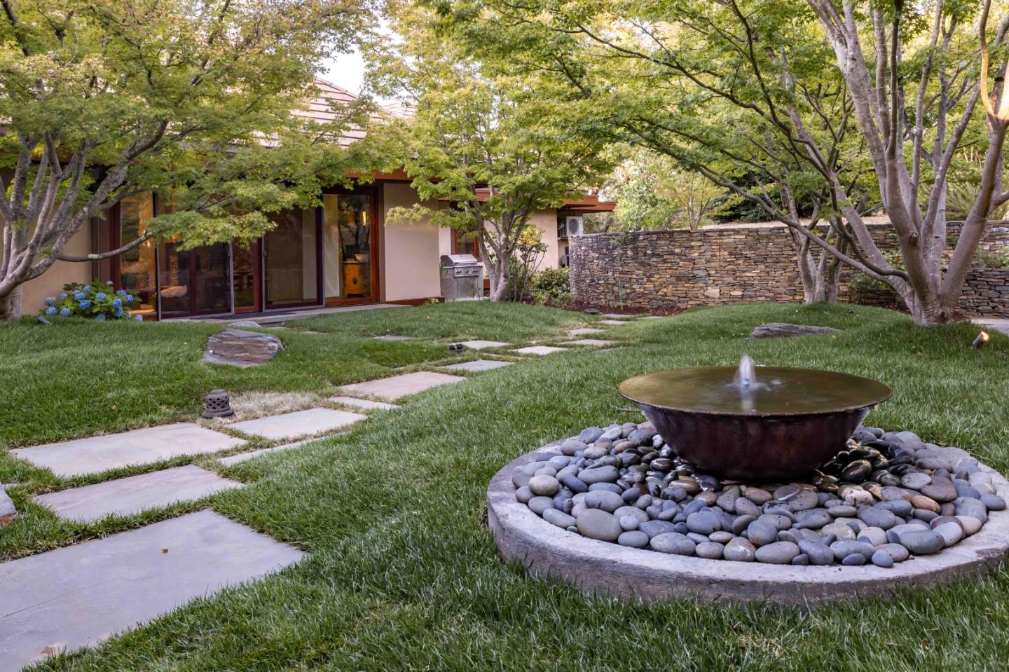 140 Farm Road Woodside, CA 94062 - Photo 28 of 39 a view of a backyard with plants and a fountain