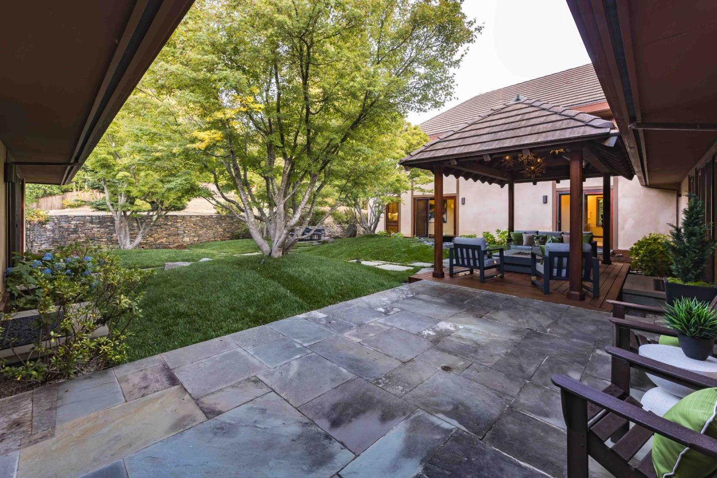 140 Farm Road Woodside, CA 94062 - Photo 29 of 39 a view of patio with chairs and tables under an umbrella with a barbeque grill