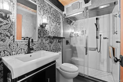 a bathroom with a sink toilet and shower