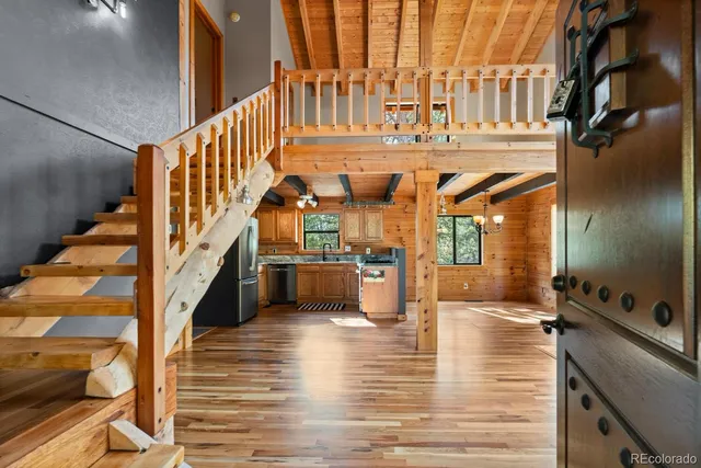 a view of a balcony with wooden fence and floor