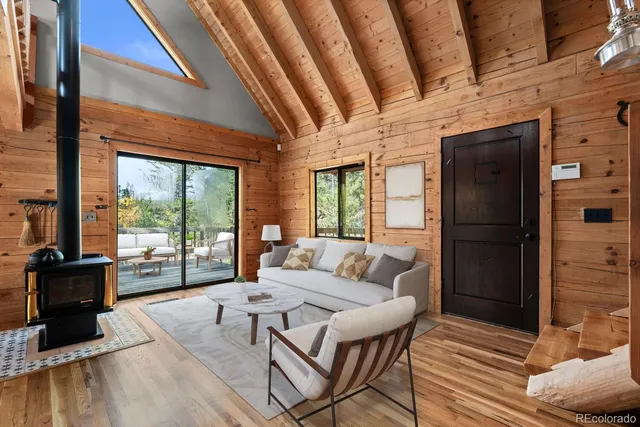 a living room with furniture and a floor to ceiling window