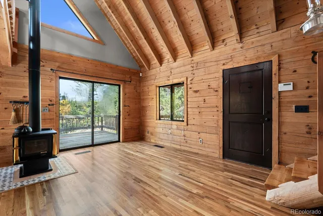 a view of a hallway with wooden floor and fence