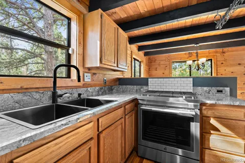 a kitchen with a stove a sink and a refrigerator