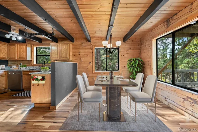 a dining room with furniture a chandelier and wooden floor