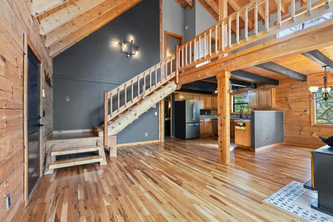 a view of entryway and hall with wooden floor