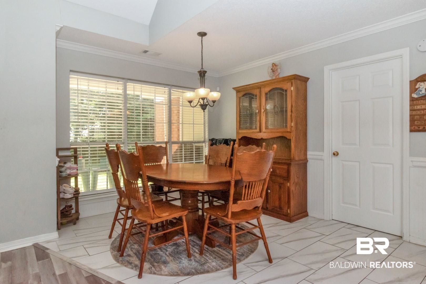 9991 Wedgefield Court Mobile, AL 36608 - Photo 11 of 30 Tiled dining space featuring crown molding and a chandelier
