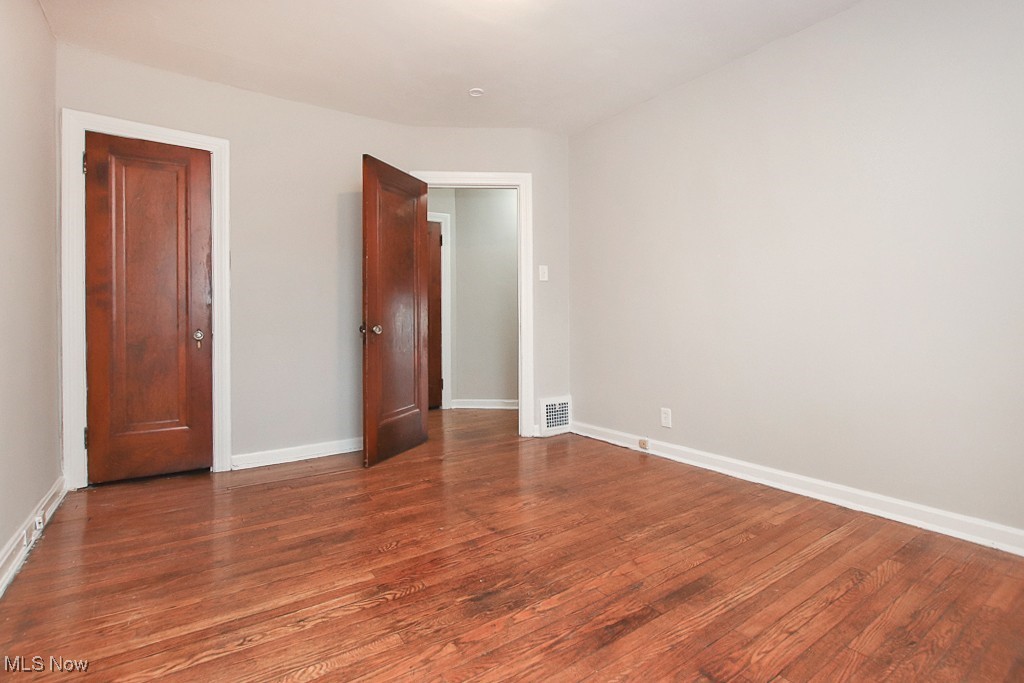 3973 Navahoe Road Cleveland, OH 44121 - Photo 10 of 14 Unfurnished room with visible vents, baseboards, and wood finished floors