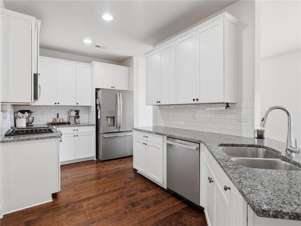 147 Fieldbrook Crossing Canton, GA 30115 - Photo 10 of 46 a kitchen with granite countertop white cabinets and stainless steel appliances