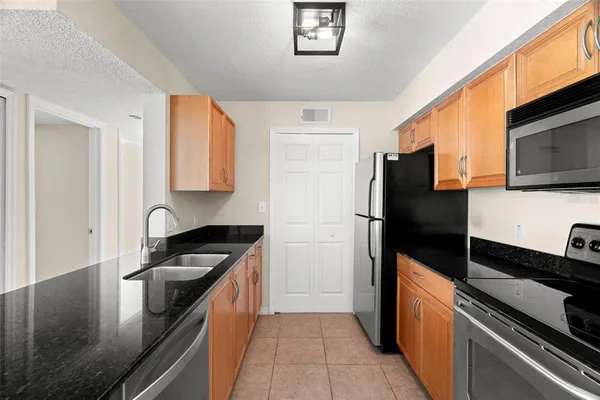 a kitchen with granite countertop a sink and cabinets