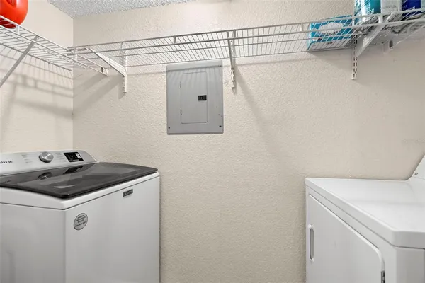 a kitchen with granite countertop wooden cabinets and a stove top oven