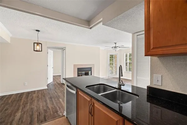 a kitchen with stainless steel appliances granite countertop a sink and a refrigerator