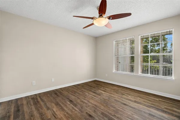 a view of a room with wooden floor
