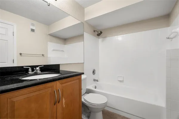 a view of an empty room with window and fire place