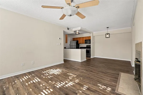 a view of empty room with wooden floor and fireplace