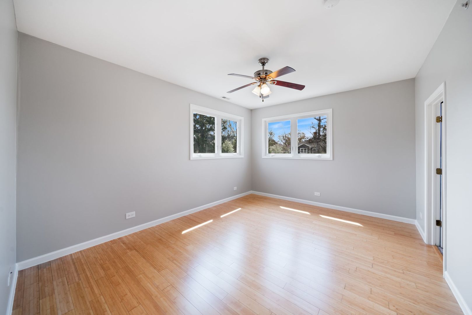 701 Oakton Street Park Ridge, IL 60068 - Photo 36 of 59 a view of a big room with wooden floor and a chandelier fan