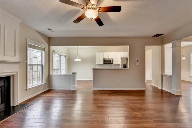 a kitchen with granite countertop a sink a stove and cabinets