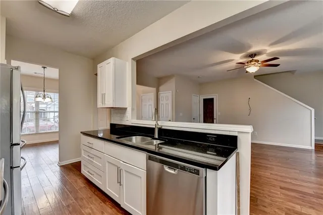 a kitchen with stainless steel appliances granite countertop a stove and a sink