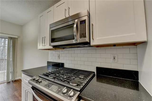 a very nice looking room with wooden floor and a window