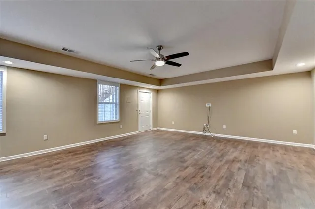 a view of an empty room with a ceiling fan