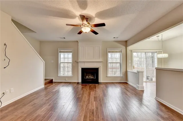 a kitchen with granite countertop cabinets stainless steel appliances and wooden floor