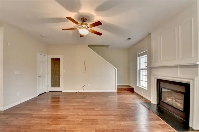 a very nice looking room with wooden floor and a window