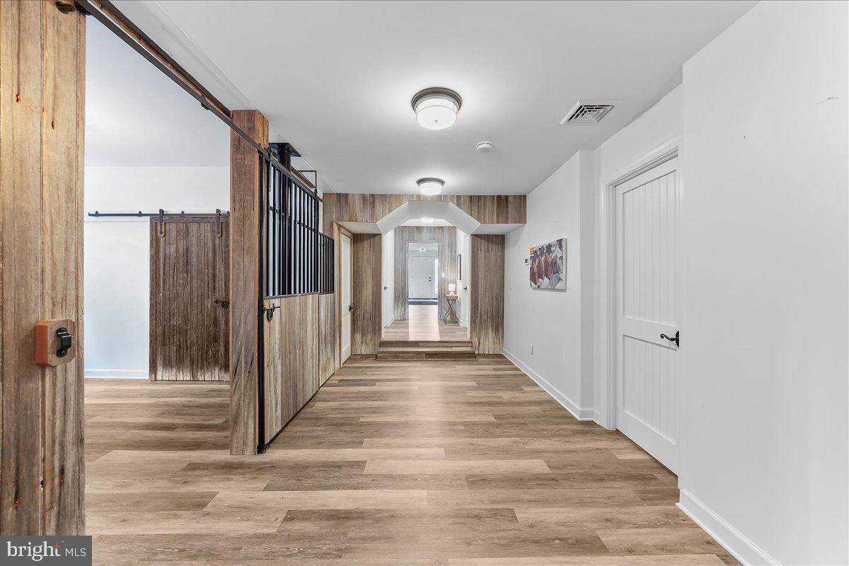 208 Haystack Lane Wilmington, DE 19807 - Photo 50 of 89 a view of a hallway with wooden floor and glass door