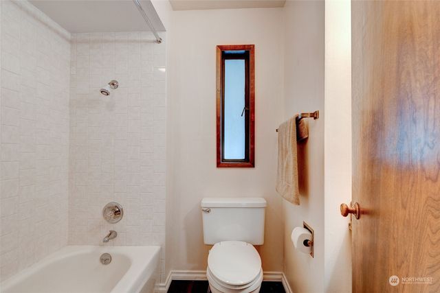a bathroom with a toilet and a bathtub