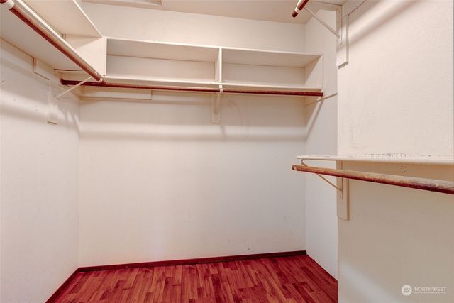 a view of walk in closet with empty racks