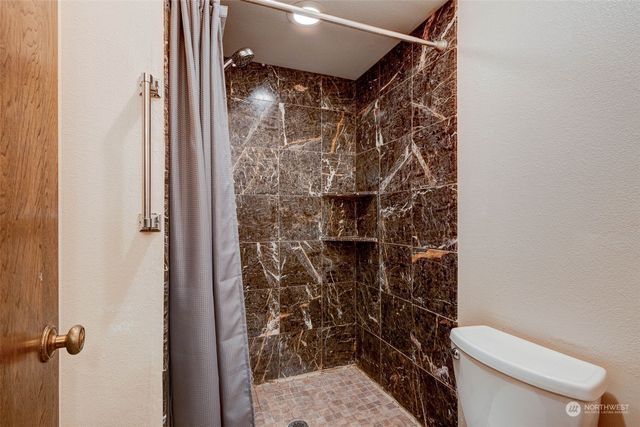 a bathroom with a toilet and shower