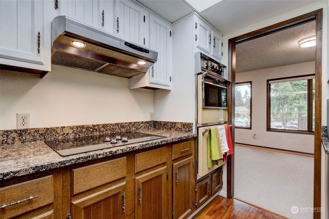 a kitchen with stainless steel appliances granite countertop a stove and a cabinets