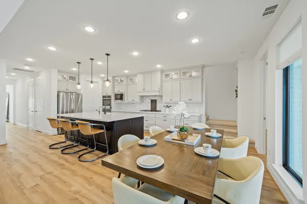 a open dining room with furniture and wooden floor