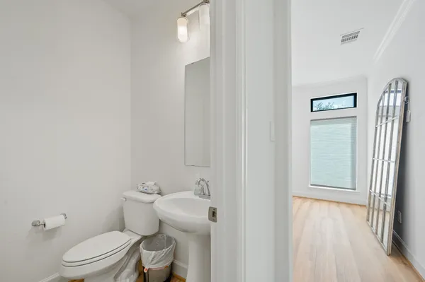 a white toilet sitting next to a bathroom sink