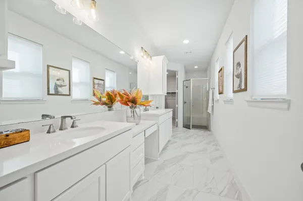 a spacious bathroom with a sink double vanity and a large mirror