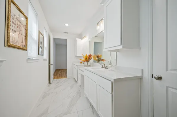 a kitchen with stainless steel appliances granite countertop a sink and dishwasher with white cabinets
