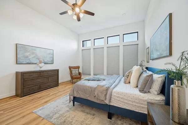 a bedroom with a bed and wooden floor