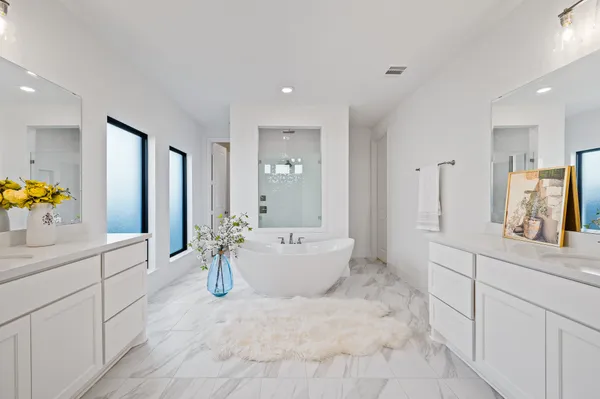a large white kitchen with a white countertops a sink and dishwasher