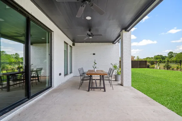 a view of a porch with furniture and yard