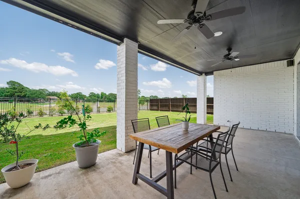 a view of a patio with a table chairs and a potted plant