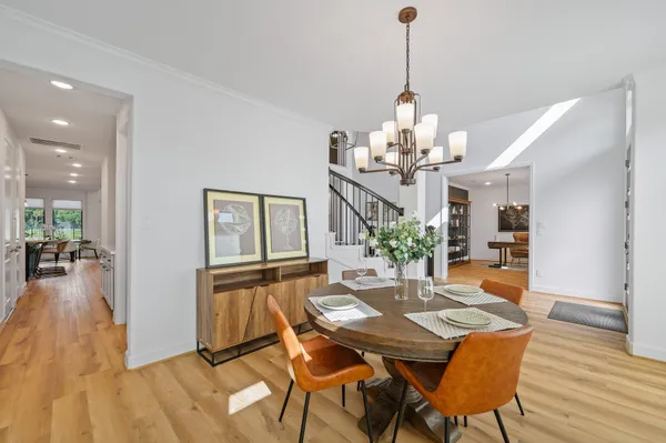 a view of a dining room with furniture wooden floor and chandelier