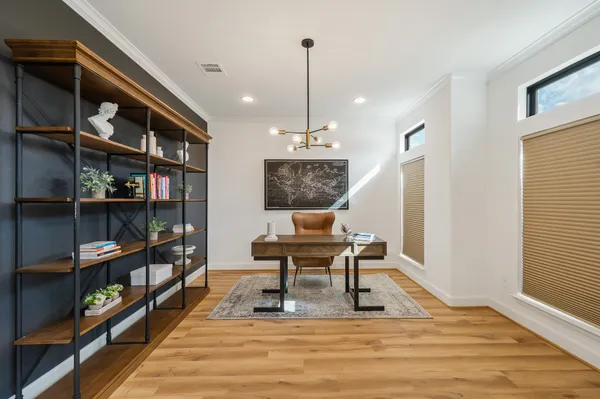 a work room with furniture and a book shelf