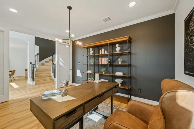 a view of entryway and hall with wooden floor