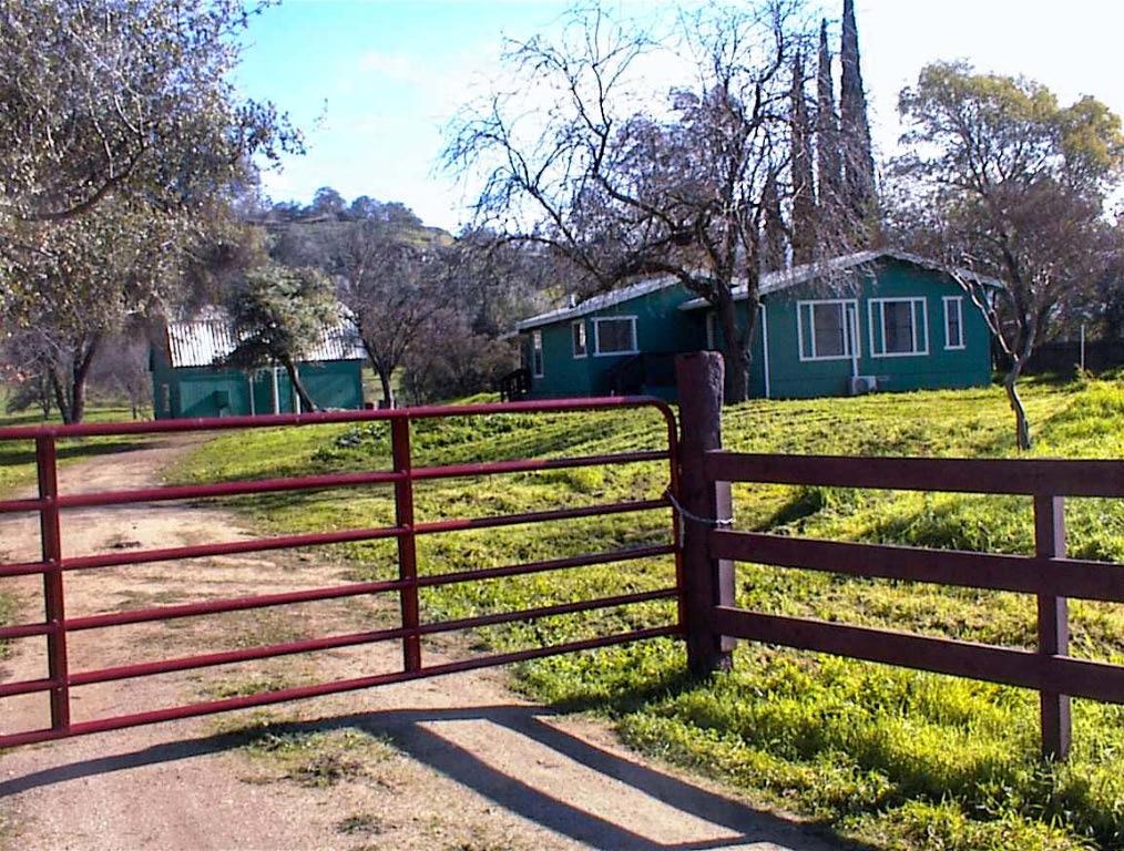 37702 Squaw Valley Road Squaw Valley, CA 93675 - Photo 2 of 42 a view of a wooden bench next to a yard